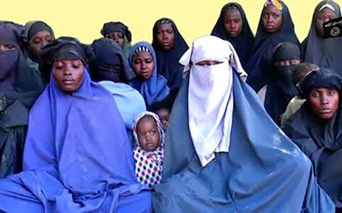 A video released by Islamist militants group Boko Haram showed at least 14 of the schoolgirls abducted in 2014 - Credit: AFP