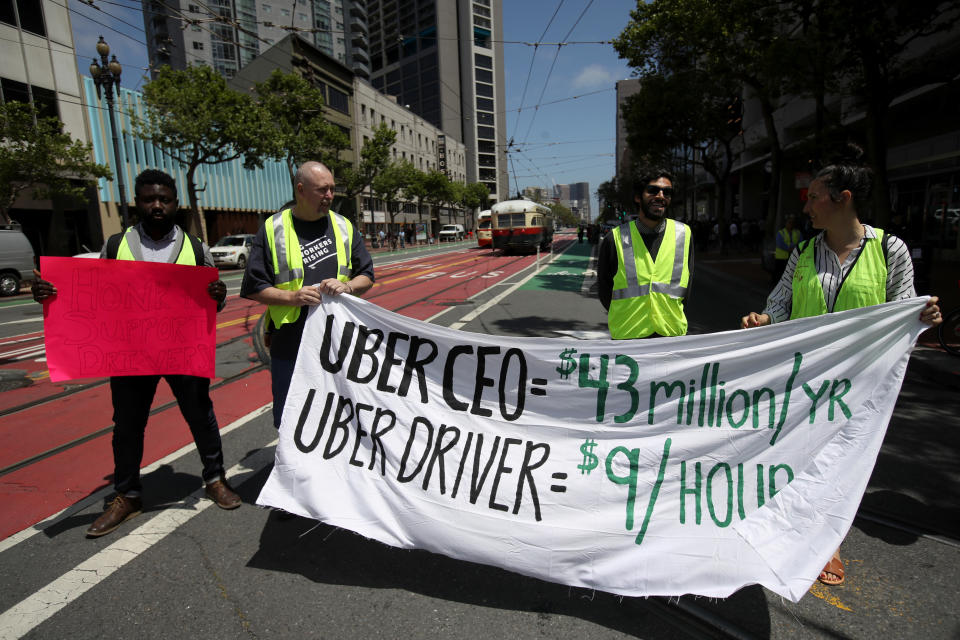 SAN FRANCISCO, CA - MAY 08: Supporters of ride share drivers from Uber and Lyft hold a sign during a protest in front of Uber headquarters on May 08, 2019 in San Francisco, California. The protests in more than a dozen cities come ahead of Uber's anticipated Initial Public Offering on the New York Stock Exchange (NYSE) which could put the ride-hailing firm's calculation as high as $91.5 billion. Drivers are seeking higher wages and better rights as employees. (Photo by Justin Sullivan/Getty Images)