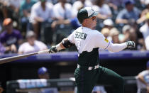 Colorado Rockies' Brian Serven follows the flight of his solo home run off Los Angeles Dodgers starting pitcher Tony Gonsolin in the third inning of a baseball game Sunday, July 31, 2022, in Denver. (AP Photo/David Zalubowski)