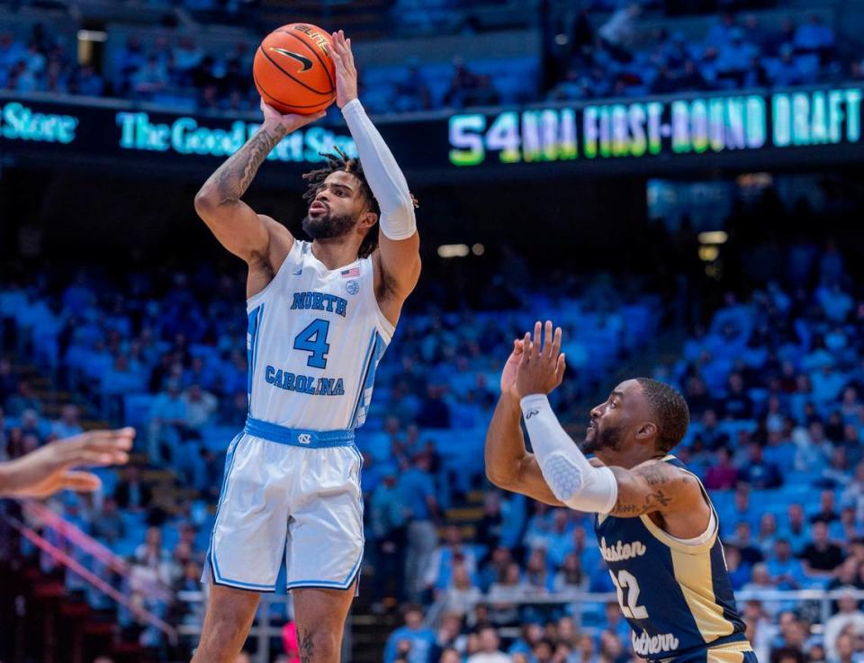 North Carolina’s R.J. Davis (4) puts up a shot over Charleston Southern’s R.J. Johnson (22) in the first half on Friday, December 29, 2023 at the Smith Center in Chapel Hill, N.C. Robert Willett/rwillett@newsobserver.com