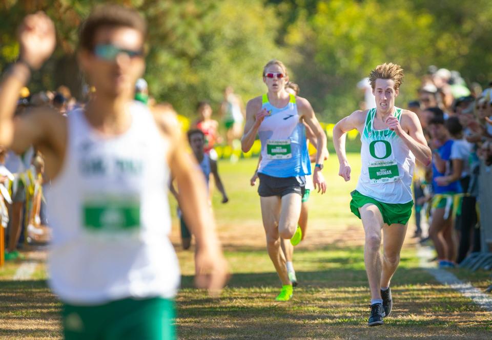 Running unattached, Oregon freshman Simeon Birnbaum, center, runs for third while Oregon's Quincy Norman, right, finishes second to Cal Poly's Davis Bove at the Dellinger Invitational at Pine Ridge Golf Club in Springfield on Sept. 22.