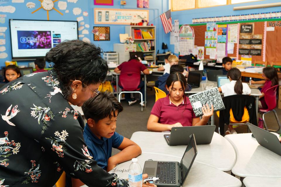 Teacher Rebecca Rivera (left) and 4th grader Adrian Antone with his work in the classroom at Stanfield Elementary school on Sept. 29, 2022, in Stanfield. Rivera teaches a combined class of 4th and 5th graders due to a teacher shortage in Stanfield.