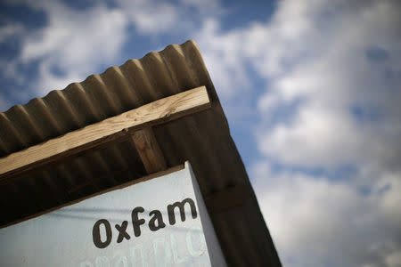 An Oxfam sign is seen on a kiosk that was used to distribute water in Corail, a camp for displaced people of the 2010 earthquake, on the outskirts of Port-au-Prince, Haiti, February 13, 2018. REUTERS/Andres Martinez Casares