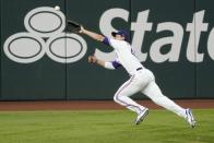 Texas Rangers left fielder Eli White is unable to reach a two-RBI double hit by Los Angeles Angels' Jo Adell in the third inning of a baseball game in Arlington, Texas, Tuesday, Aug. 3, 2021. The hit scored Justin Upton and Phil Gosselin. (AP Photo/Tony Gutierrez)