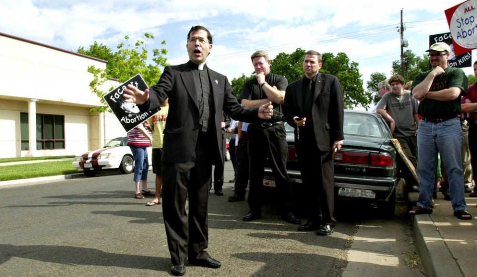 The Rev. Frank Pavone, center, and other members of Priests for Life protest outside Planned Parenthood of Amarillo, Texas.