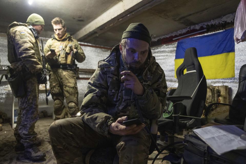 A Ukrainian marine serviceman speaks on a radio inside a shelter, in the frontline city of Vuhledar, Ukraine, Saturday, Feb. 25, 2023. (AP Photo/Evgeniy Maloletka)