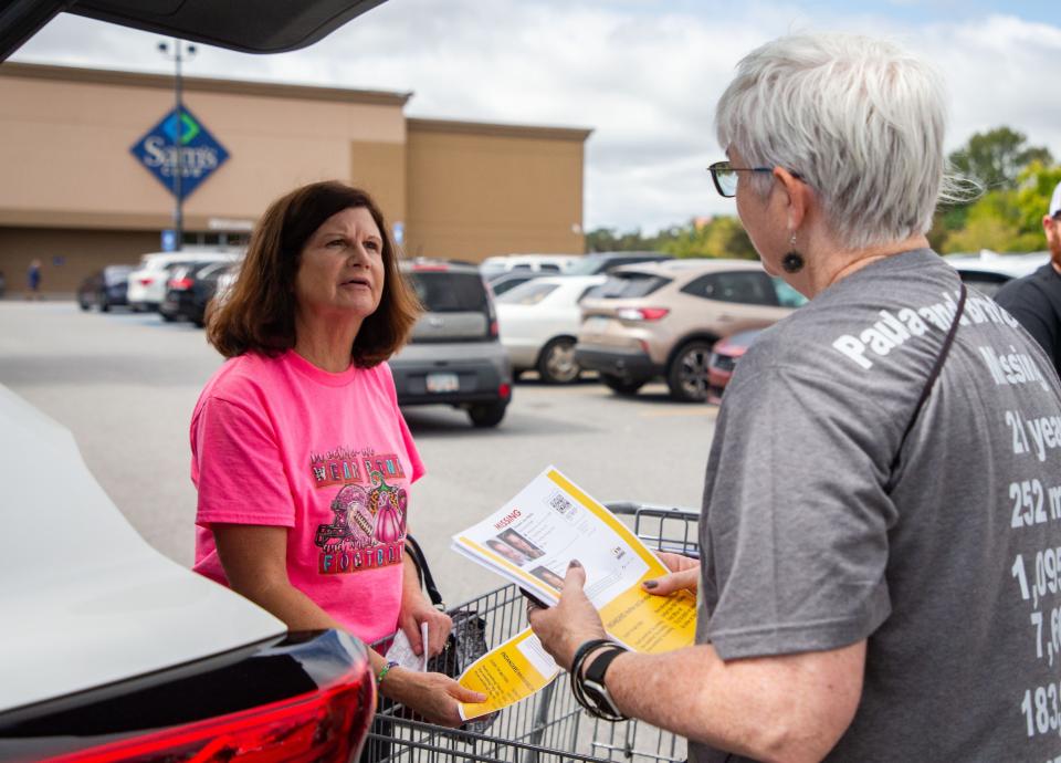 On Saturday, the 21-year anniversary of Paula Wade and her son's disappearance, Wade’s older sister, Mary Ramsbottom, passes out missing persons flyers to people in the parking lot of the Sam’s Club in Valdosta, Georgia.