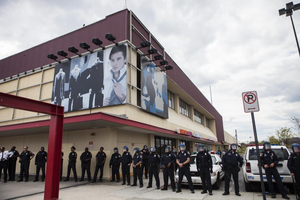 Police line up outside Mondawmin Mall during riots in Baltimore, USA on April 27, 2015. Protests following the death of Freddie Gray from injuries suffered while in police custody have turned violent with people throwing debris at police and media and burning cars and businesses. (Photo by Samuel Corum/Anadolu Agency/Getty Images)