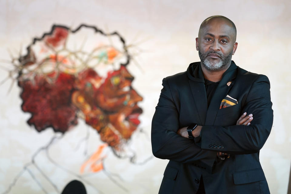 CORRECTS SPELLING TO REV. EARLE FISHER NOT REV. EARL FISCHER Rev. Earle Fisher, of the Abyssinian Missionary Baptist Church, poses by an unfinished portrait of Christ on a wall of the facility Oct. 25, 2022, in Memphis, Tenn. Fisher, whose colleague Autura Eason-Williams was among the victims of gun violence in Memphis, said he was skeptical that non-profit Youth Villages can succeed in helping to reduce shootings in the city because they have not done this kind of work before. (AP Photo/Mark Humphrey)