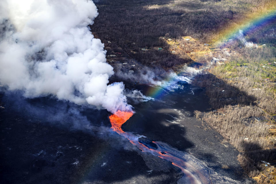 <p>The Kilauea volcano on Hawaii’s Big Island erupted on May 3, 2018, and has continued to send lava over the surrounding neighborhoods. (Photo: CJ Kale/Caters News) </p>