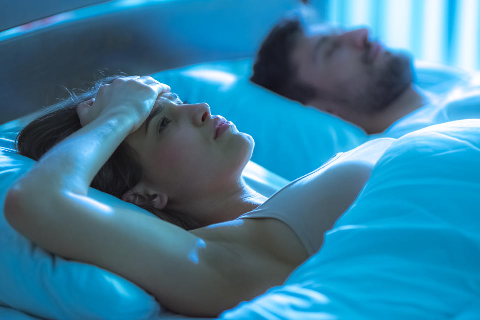 Woman lying awake in bed. (Getty Images)