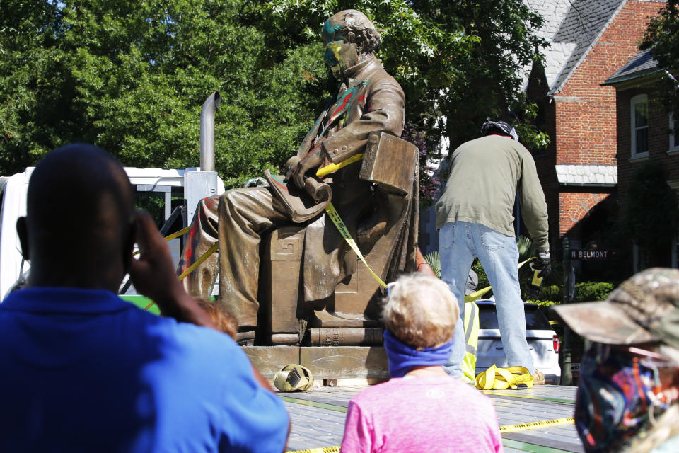 Workers secure the statue of Confederate Naval officer Matthew Fontaine Maury to a truck on Monument Avenue, Thursday, July 2, 2020, in Richmond, Va. Maury was better known for his work in oceanography and other sciences before the Civil War. His statue is the second removed since a new state law was enacted on July first. (AP Photo/Steve Helber)