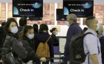 Passengers prepare at Sydney Airport, in Sydney, Australia, Monday, April 19, 2021, to catch a flight to New Zealand as the much-anticipated travel bubble between Australia and New Zealand opens. (AP Photo/Rick Rycroft)