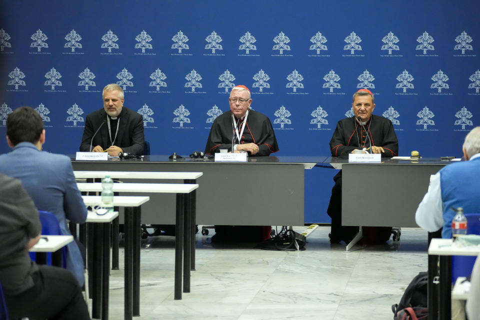 From left, Father Giacomo Costa, Cardinal Jean-Claude Hollerich and Cardinal Cardinal Mario Grech talk to reporters during a press conference for the closing of the 16th general assembly of the synod of bishops, at the Vatican's press room, in Rome, Saturday, Oct. 28, 2023. (AP Photo/Andrew Medichini)