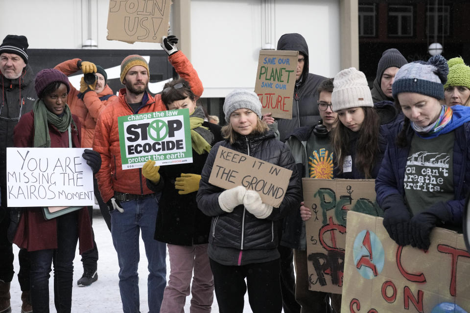 Climate activists Greta Thunberg, center, of Sweden and Vanessa Nakate, second from left, of Uganda attend a climate protest with Helena Gualinga of Ecuador, Luisa Neubauer of Germany alongside the World Economic Forum in Davos, Switzerland Friday, Jan. 20, 2023. The annual meeting of the World Economic Forum is taking place in Davos from Jan. 16 until Jan. 20, 2023. (AP Photo/Markus Schreiber)