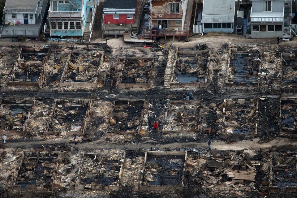 Burned houses are seen next to those which survived in Breezy Point, Queens.