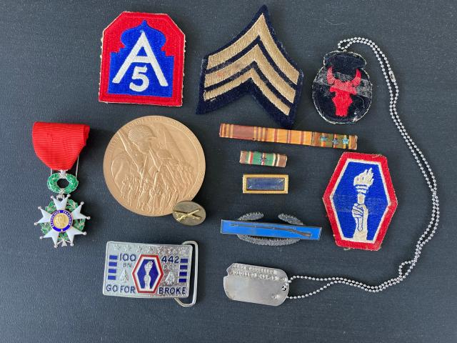 Iwao Yonemitsu&#39;s medals -- the Legion of Honor from France beside the Congressional Gold Medal. Also note the &quot;Go For Broke&quot; belt buckle.