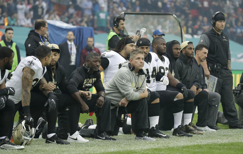 Saints players, including coach Sean Payton, kneel before the team’s game on Oct. 1. One New Orleans season ticket holder is suing the team because of the protests. (AP)