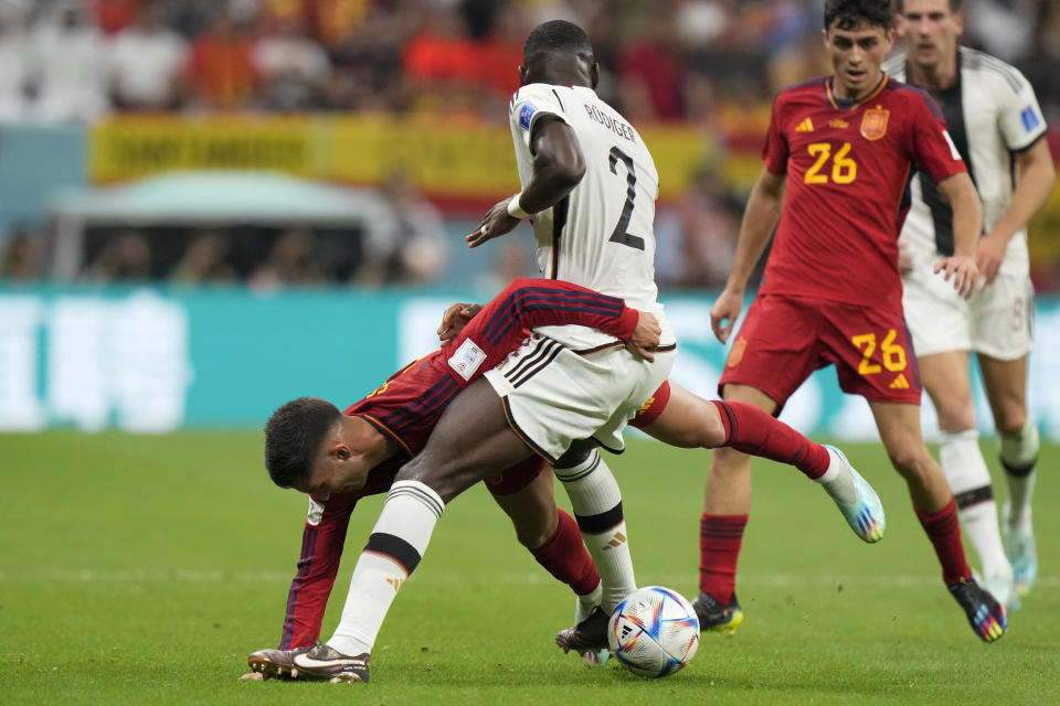 Spain's Ferran Torres, left, and Germany's Antonio Ruediger fight for the ball during the World Cup group E soccer match between Spain and Germany, at the Al Bayt Stadium in Al Khor , Qatar, Sunday, Nov. 27, 2022. (AP Photo/Luca Bruno)