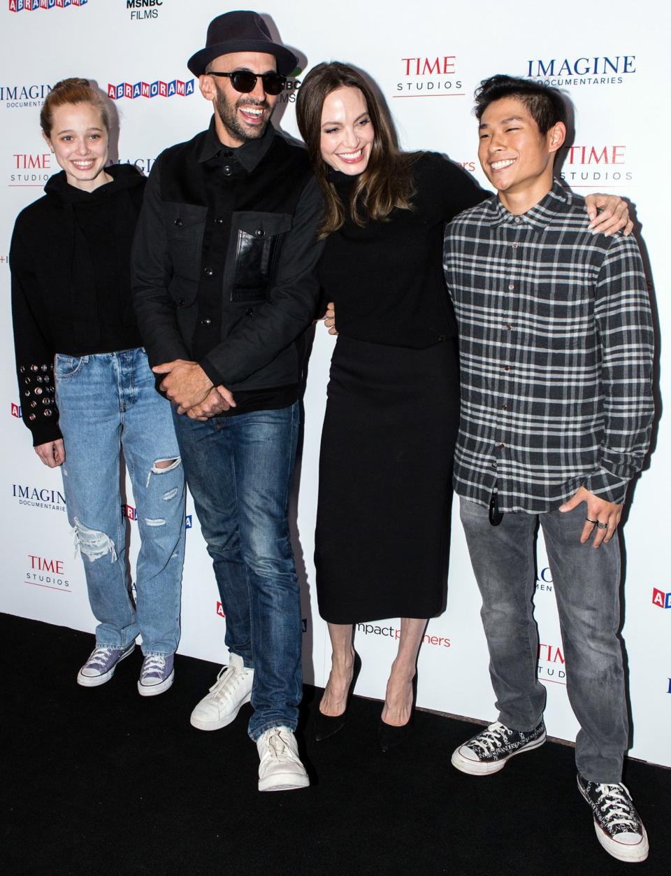 <p>Angelina Jolie and her children, Shiloh Jolie-Pitt (left) and Pax Thien Jolie-Pitt (right), pose with street artist JR (center) at the L.A. premiere of <em>Paper & Glue: A JR Project </em>on Nov. 18.</p>