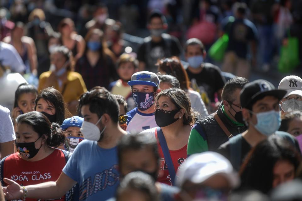 People walk in downtown in Mexico City on December 13, 2020, amid the COVID-19 pandemic. (Photo by PEDRO PARDO / AFP) (Photo by PEDRO PARDO/AFP via Getty Images)