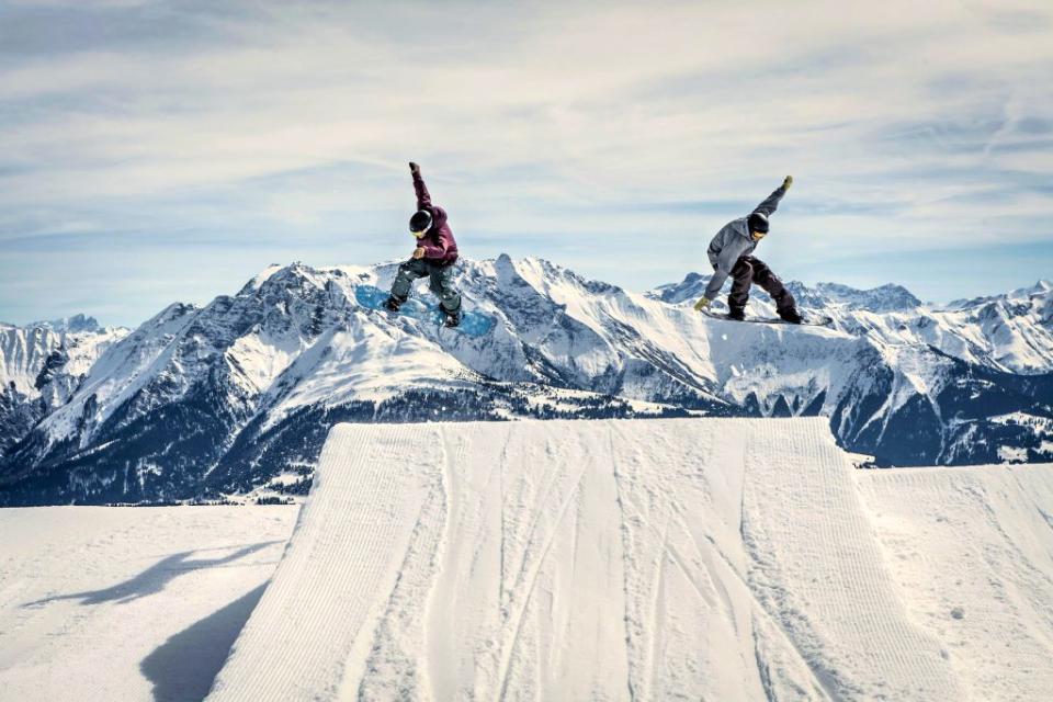 snowboarders on a halfpipe in Switzerland
