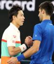 Tennis - Australian Open - Quarter-final - Melbourne Park, Melbourne, Australia, January 23, 2019. Japan's Kei Nishikori and Serbia's Novak Djokovic shake hands after the match. REUTERS/Lucy Nicholson