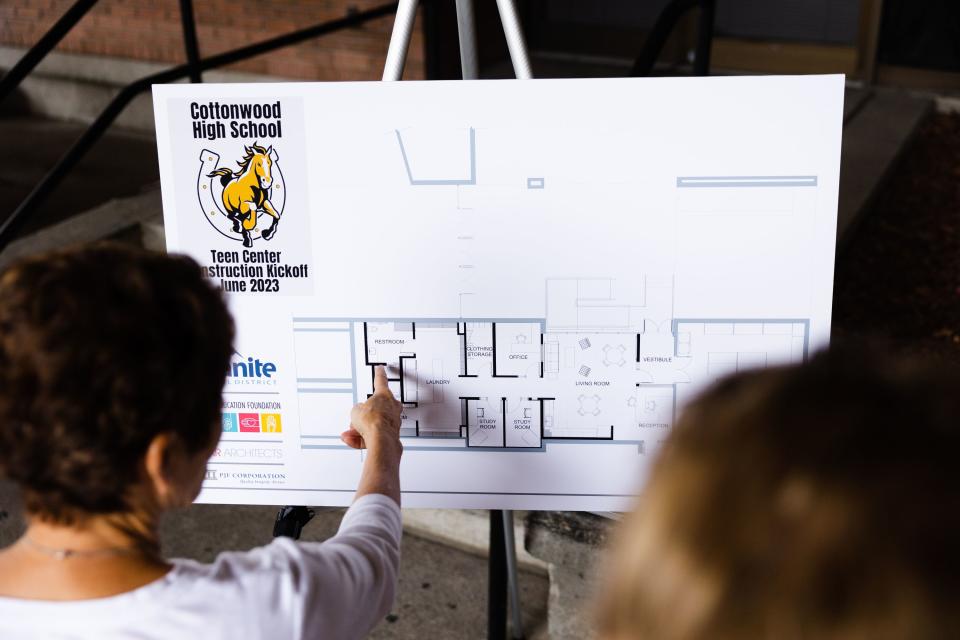 Fidge Preston, left, and Earlene Rex, volunteers for the hygiene section of the Cottonwood High School food pantry, look at building blueprints during a groundbreaking event for a teen resource center at Cottonwood High School in Murray on Thursday, June 1, 2023. | Ryan Sun, Deseret News