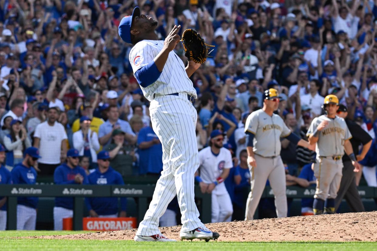 Chicago pitcher Hector Neris reacts after the Cubs beat the Milwaukee Brewers at Wrigley Field on Saturday.