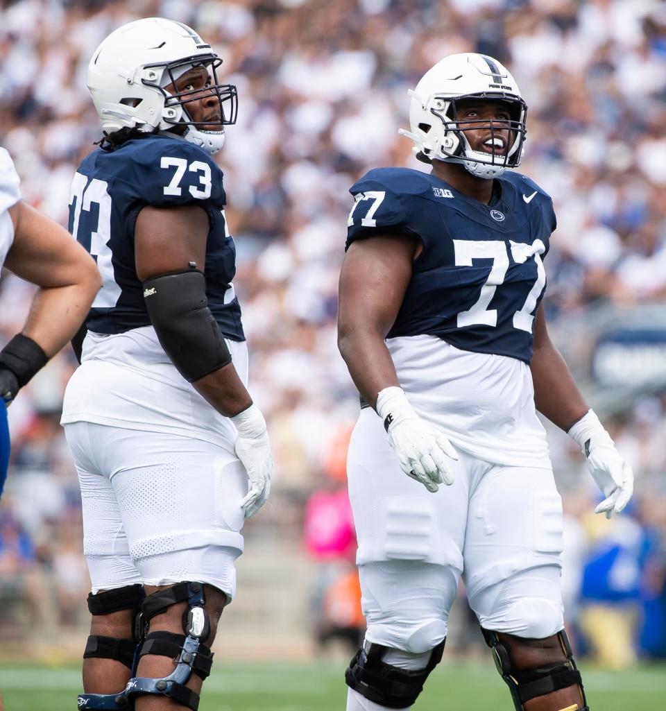 Penn State offensive linemen Caedan Wallace (73) and Sal Wormley (77) look up at the video board after a play during a NCAA football game against Delaware Saturday, Sept. 9, 2023, in State College, Pa.