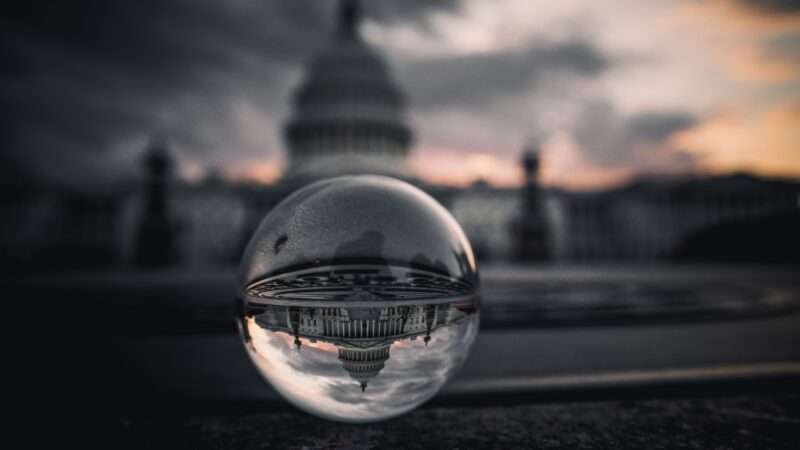 An artistic photo of the U.S. Capitol seen through a clear sphere