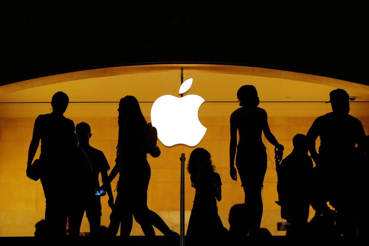 Customers walk past an Apple logo inside of an Apple store at Grand Central Station in New York, U.S., August 1, 2018.  REUTERS/Lucas Jackson