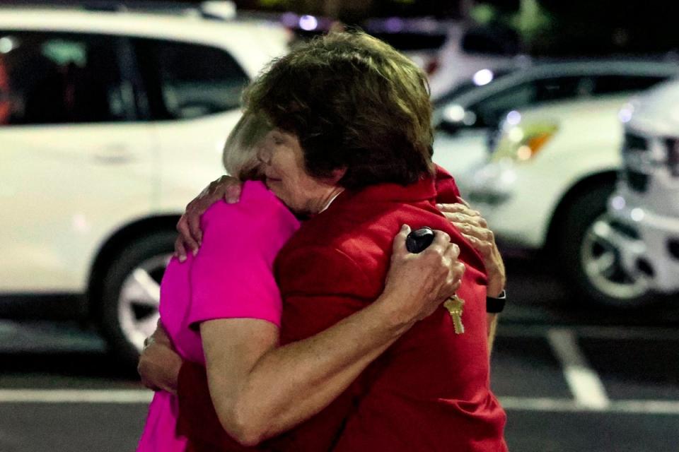 Members of the Saint Stephens Episcopal Church, in Vestavia, Alabama, embrace after a gunman opened fire at a pot luck dinner (AP)