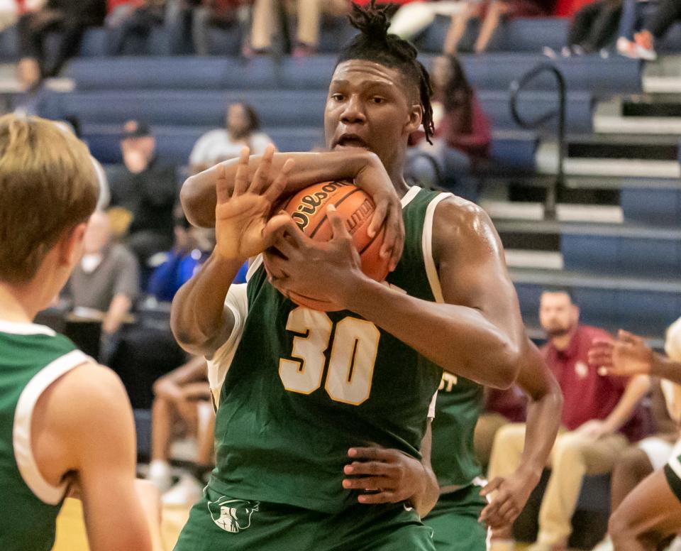 Suncoast Ian Smikle (30) grabs the rebound as North Marion High School takes on Suncoast High School in the Kingdom of the Sun basketball tourney  Thursday, Dec. 29, 2022, at Vanguard High School in Ocala, Fla. [Alan Youngblood/\Ocala Star-Banner]