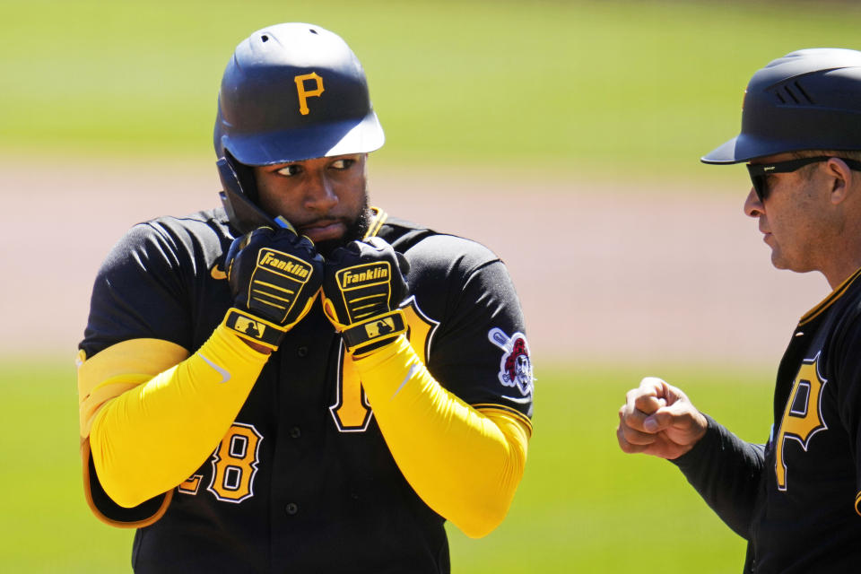 Pittsburgh Pirates' Canaan Smith-Njigba, left, celebrates with third base coach Mike Rabelo after hitting a triple off Chicago White Sox starting pitcher Michael Kopech, driving in a run during the second inning of a baseball game in Pittsburgh, Sunday, April 9, 2023. (AP Photo/Gene J. Puskar)