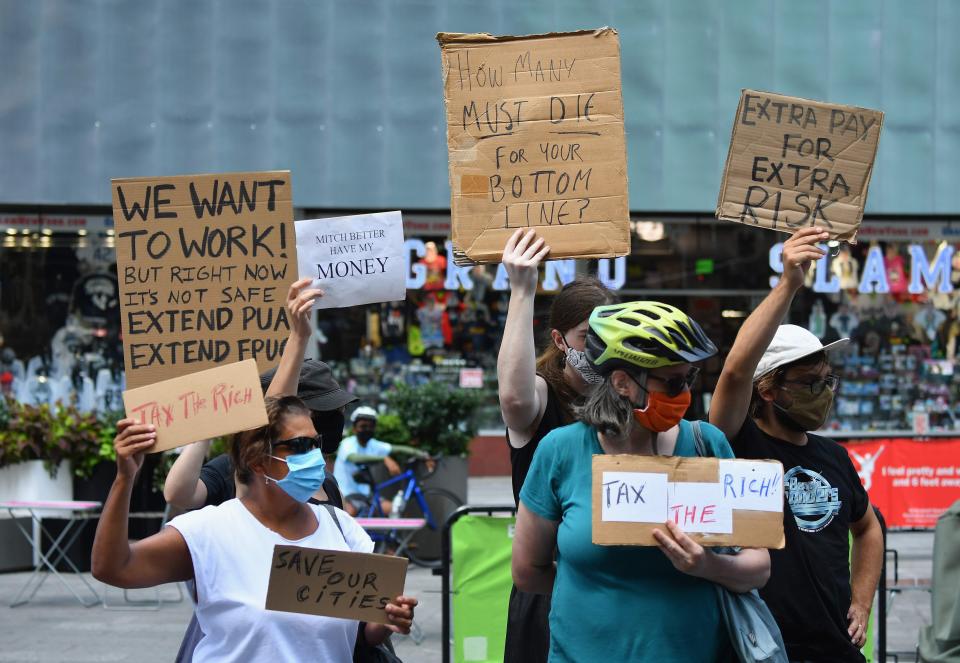 Protesters demand economic relief at New York's Time Square on Aug. 5. President Joe Biden has signed an executive order extending an eviction moratorium, but policy analysts have said loopholes do not universally protect tenants.