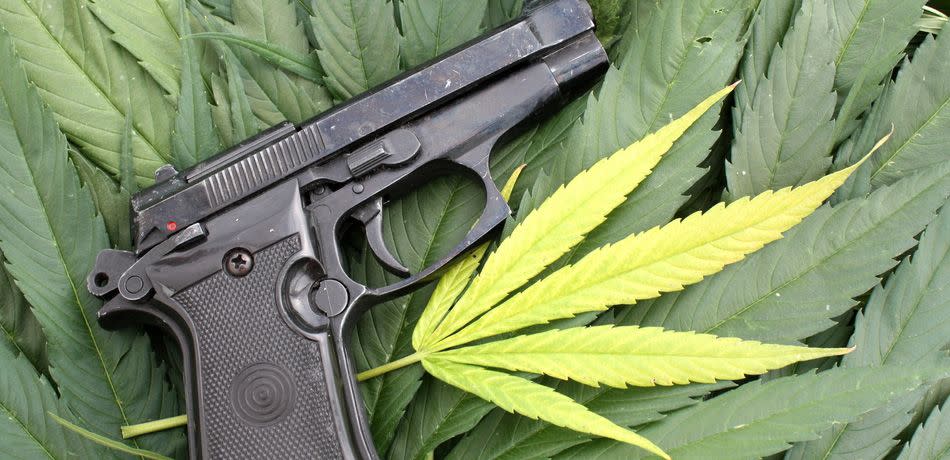 Handgun with a marijuana leaf background