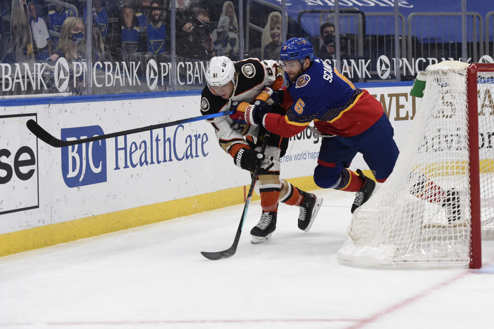 St. Louis Blues' Marco Scandella (6) checks Anaheim Ducks' Troy Terry (61) during the third period of an NHL hockey game on Monday, May 3, 2021, in St. Louis. (AP Photo/Joe Puetz)