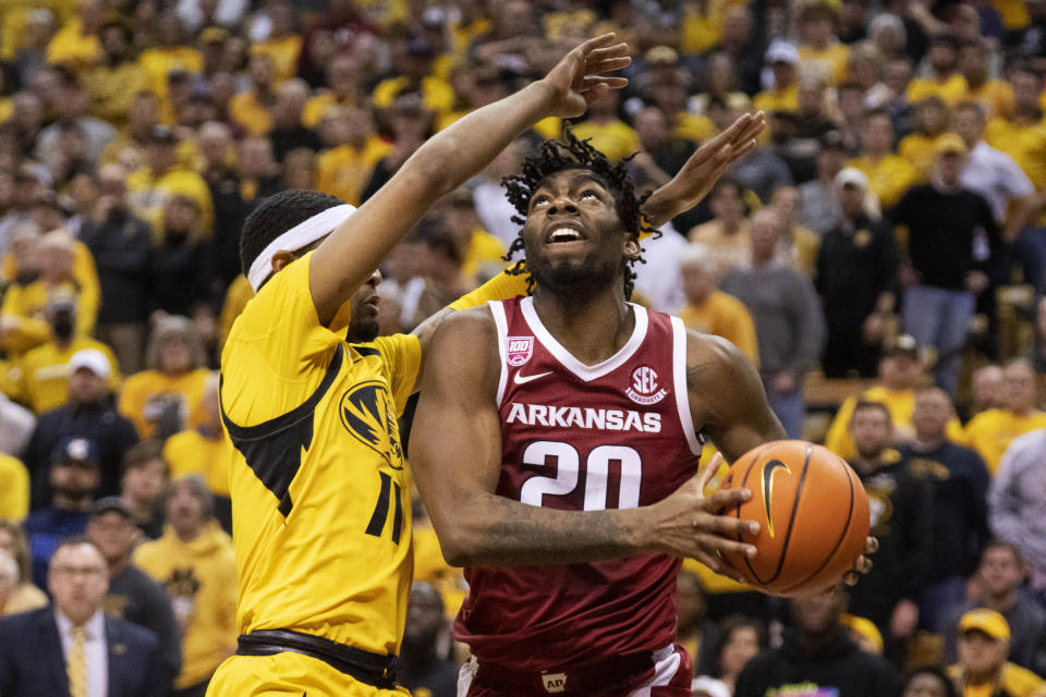 Arkansas' Kamani Johnson, right, shoots past Missouri's Isiaih Mosley, left, during the first half of an NCAA college basketball game Wednesday, Jan. 18, 2023, in Columbia, Mo. (AP Photo/L.G. Patterson)