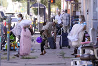 People are seen about the sidewalk on Jefferson Ave in the Oak Cliff section of Dallas, Wednesday, Sept. 22, 2021. Texas this week will begin redrawing congressional lines, and Latino advocates and officeholders say it's time to correct past wrongs. The state's explosive population growth over the past decade, half of which comes from Latinos, has earned it two new congressional seats. (AP Photo/LM Otero)