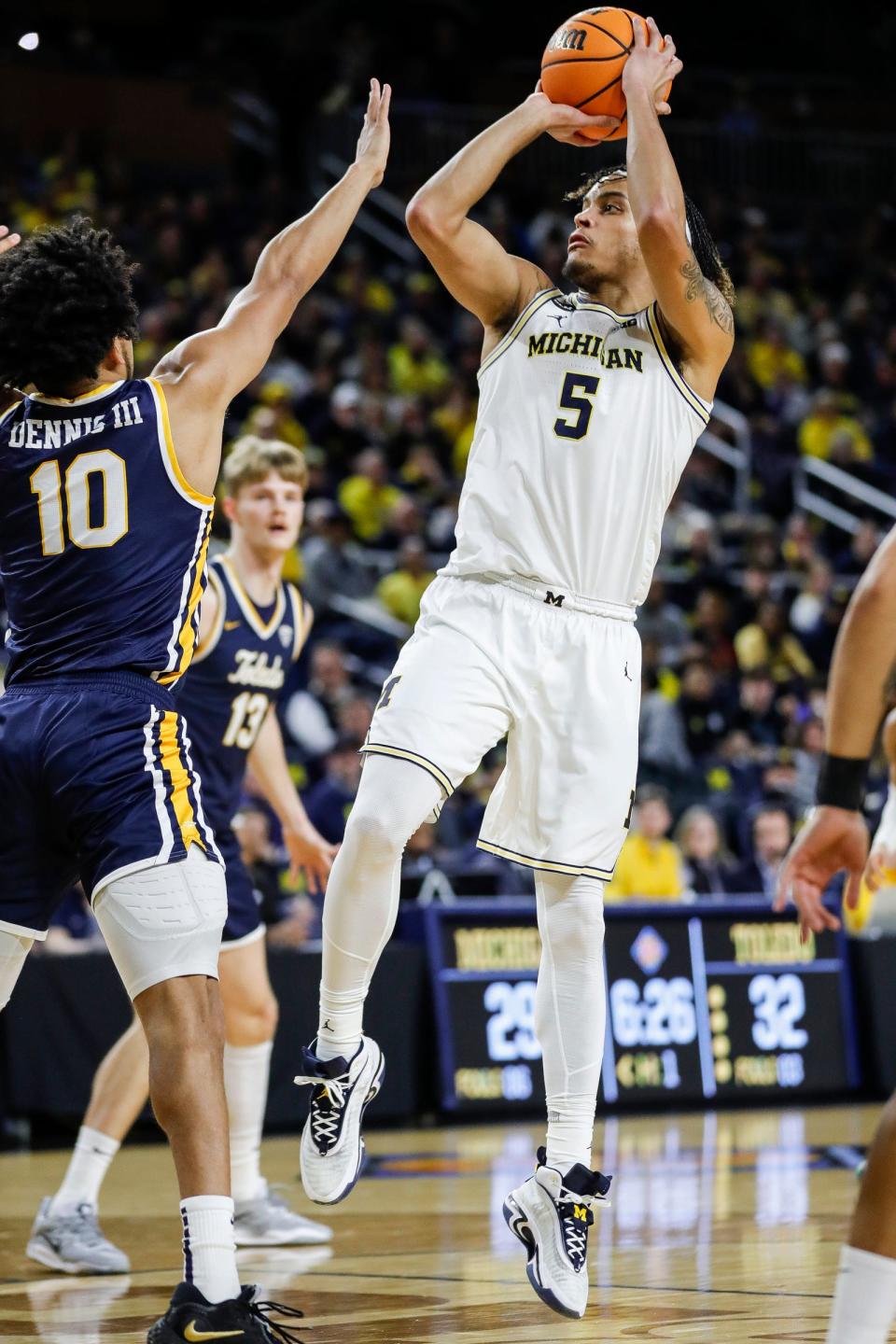 Michigan forward Terrance Williams II (5) makes a jump shot against Toledo guard RayJ Dennis (10) during the first half of the first round of the NIT at Crisler Center in Ann Arbor on Tuesday, March 14, 2023.