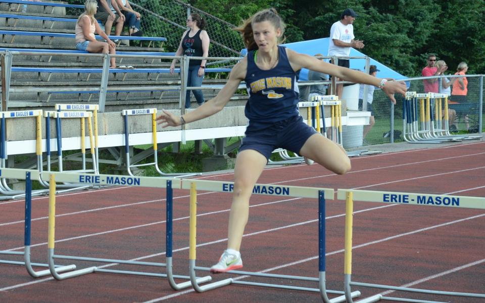 Beth Sweeney of Erie Mason runs to victory in the low hurdles at the Tri-County Conference track and field championships on Tuesday, May 21, 2024.