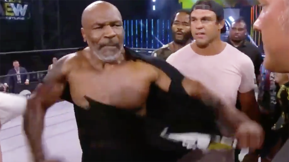 Mike Tyson is pictured attempting to tear his shirt off during an All-Elite Wrestling appearance.