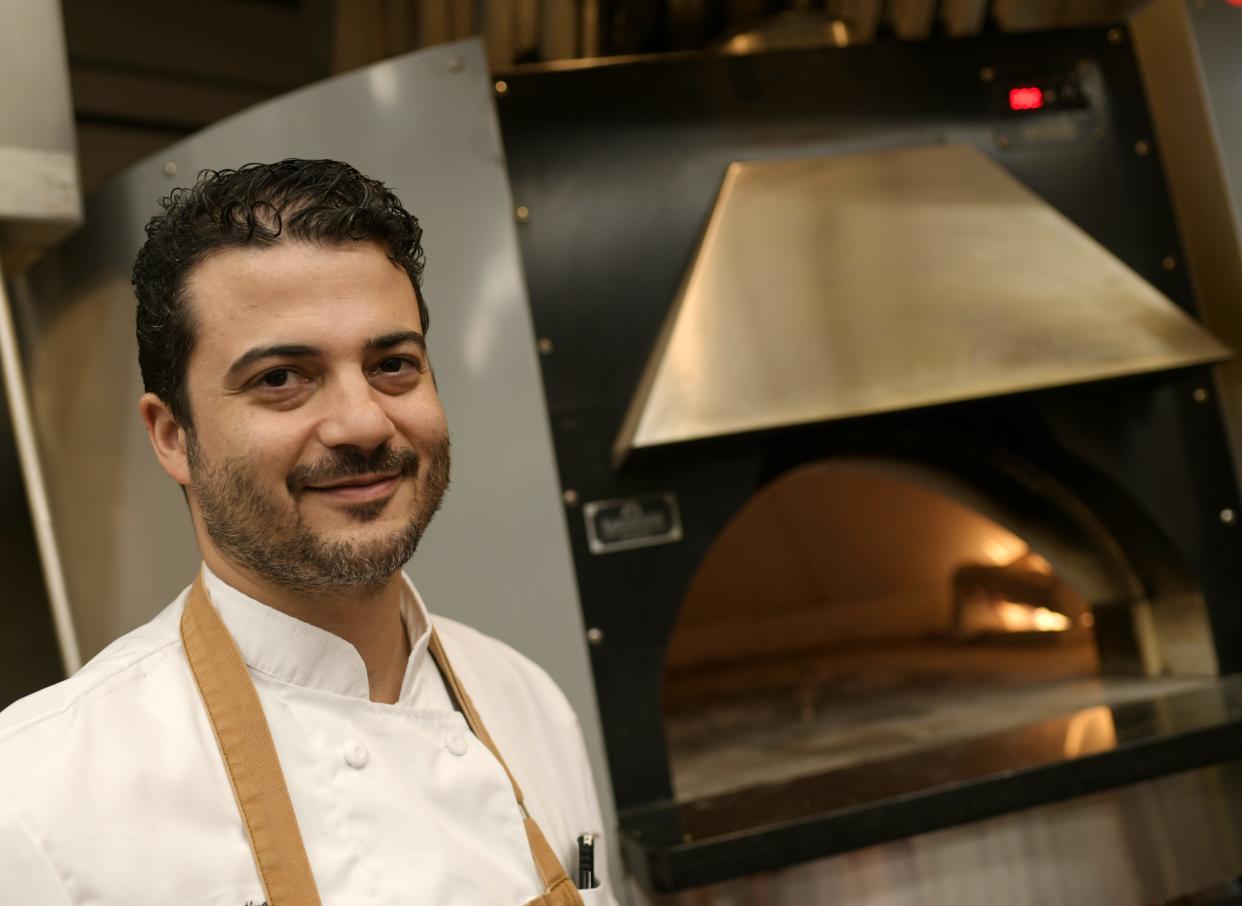 Chef Rick Araujo, shown here at The District Woodfire Kitchen, has left Off the Rails for a job at Nichols College.