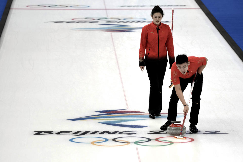 China's Fan Suyuan, left, and Ling Zhi compete during their mixed doubles curling match against Switzerland at the 2022 Winter Olympics, Wednesday, Feb. 2, 2022, in Beijing. (AP Photo/Nariman El-Mofty)