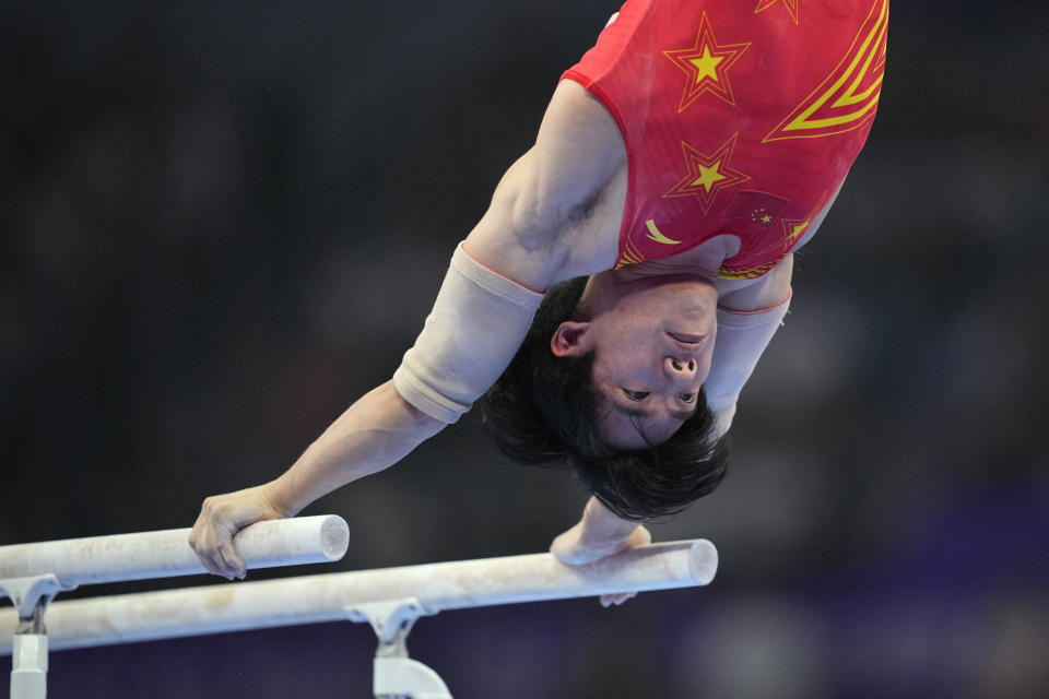 Zhang Boheng of China competes on the parallel bars during the men's all-around individuals gymnastics event of the 19th Asian Games in Hangzhou, China, Tuesday, Sept. 26, 2023. (AP Photo/Aaron Favila)