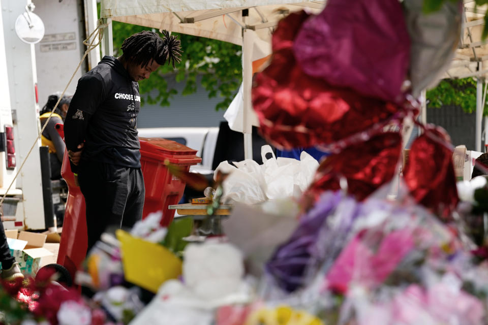 Buffalo Bills' Josh Thomas visits the scene of Saturday's shooting at a supermarket, in Buffalo, N.Y., Wednesday, May 18, 2022. (AP Photo/Matt Rourke)