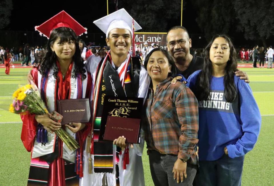 Valedictorian Cristián Avendano Cabrera poses with his parents María del Rosario and Fabián Salas, sister Enmma Avendano, and girlfriend/graduate Yareli Nonato-Cruz after the McLane High graduation at the school stadium on June 6, 2023.