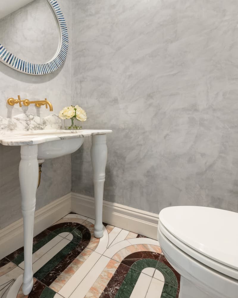 Grey lime-washed powder room.