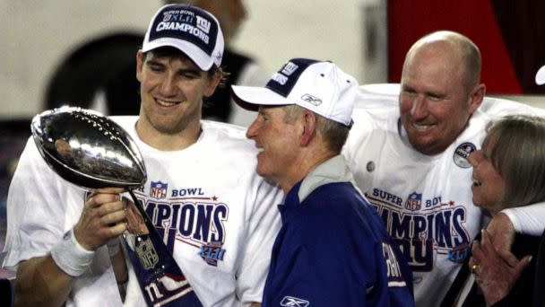 PHOTO: New York Giants quarterback Eli Manning holds the Lombardi Trophy with Head Coach Tom Coughlin and Jeff Feagles after winning Super Bowl XLII, Feb. 3, 2008, in Glendale, Az. (Linda Cataffo/NY Daily News via Getty Images)